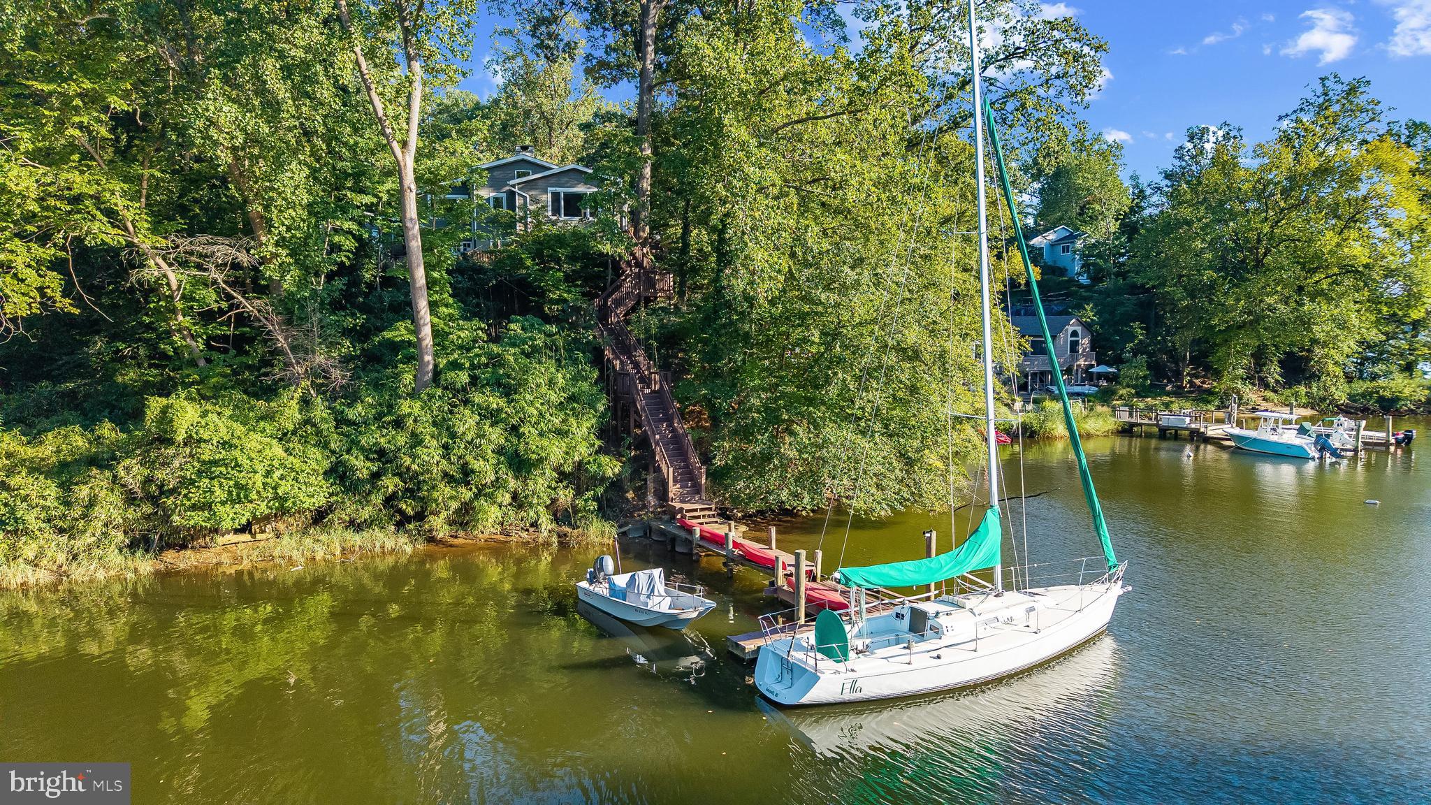 1428 Ravine Way Arnold, MD 21012 - Photo 26 of 43 a view of a lake with a yard and large trees