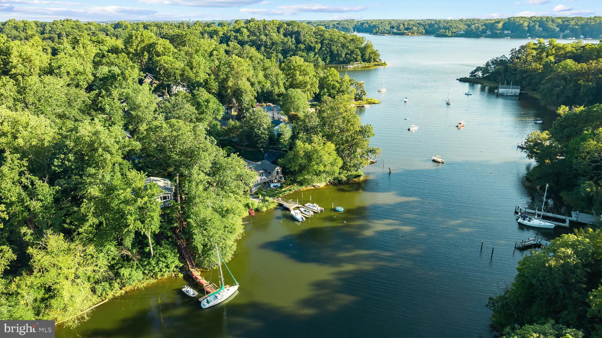1428 Ravine Way Arnold, MD 21012 - Photo 32 of 43 a view of a lake with a yard and mountain view