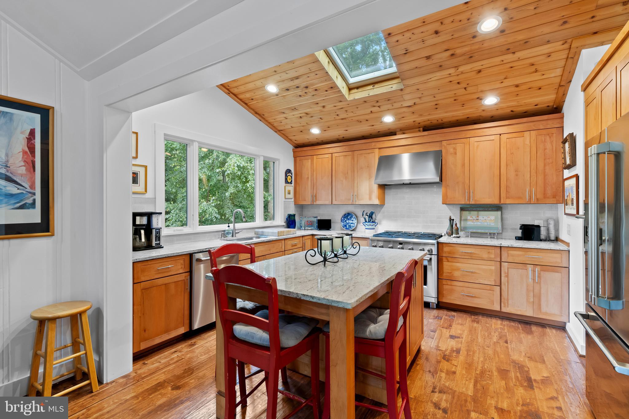 1428 Ravine Way Arnold, MD 21012 - Photo 5 of 43 a kitchen with stainless steel appliances granite countertop a stove a sink dishwasher and a refrigerator with wooden floor