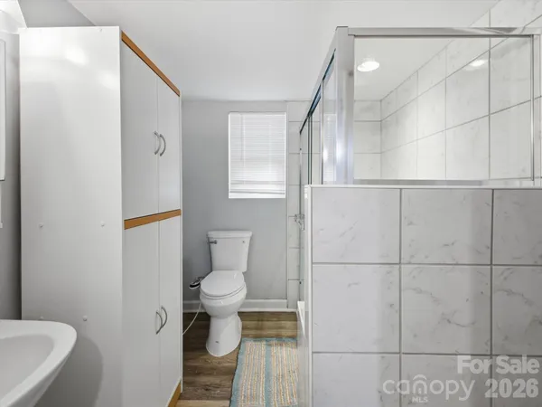 a bathroom with a toilet and a shower