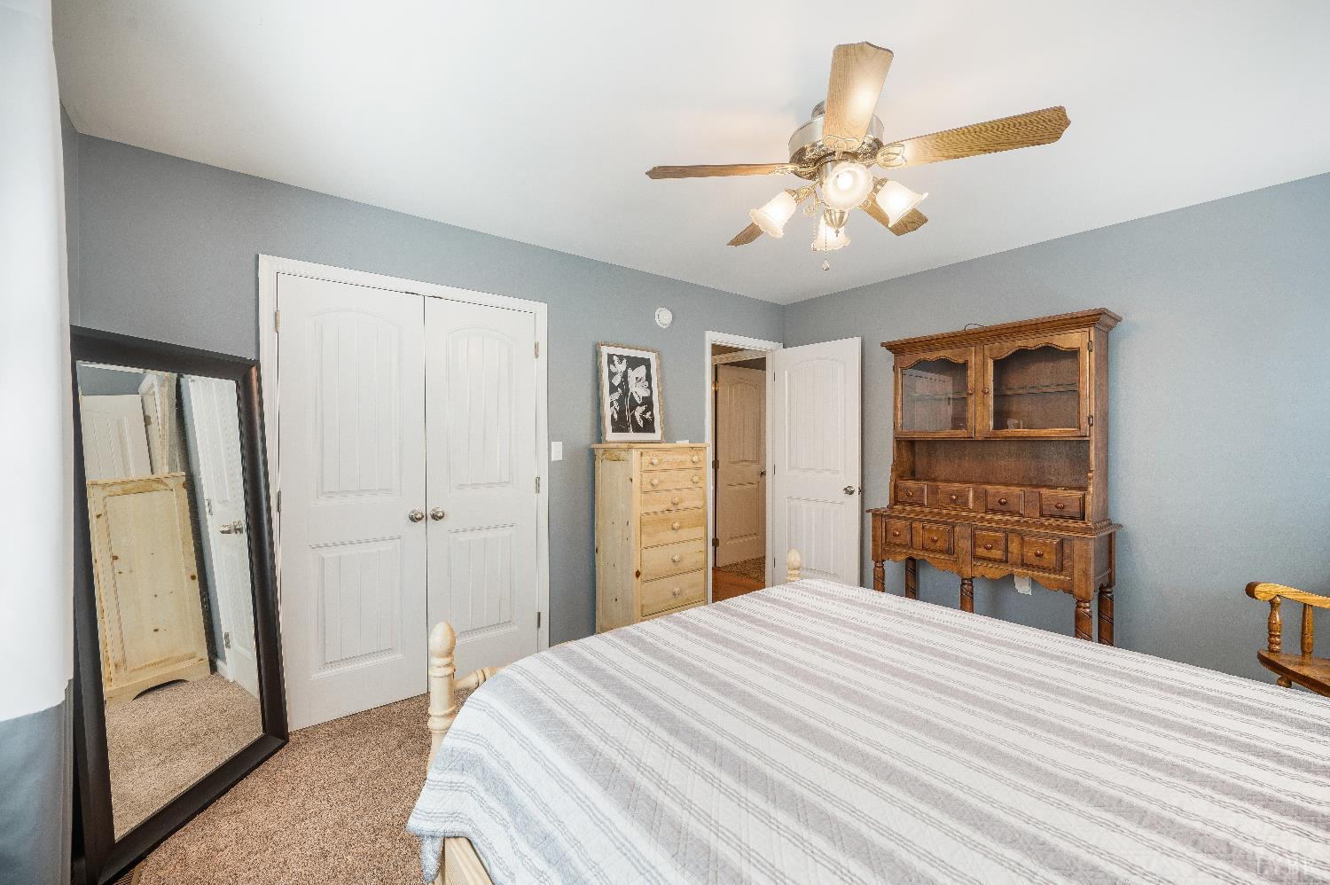 405 Marston Street Spout Spring, VA 24593 - Photo 23 of 58 a bedroom with a large bed and a chandelier