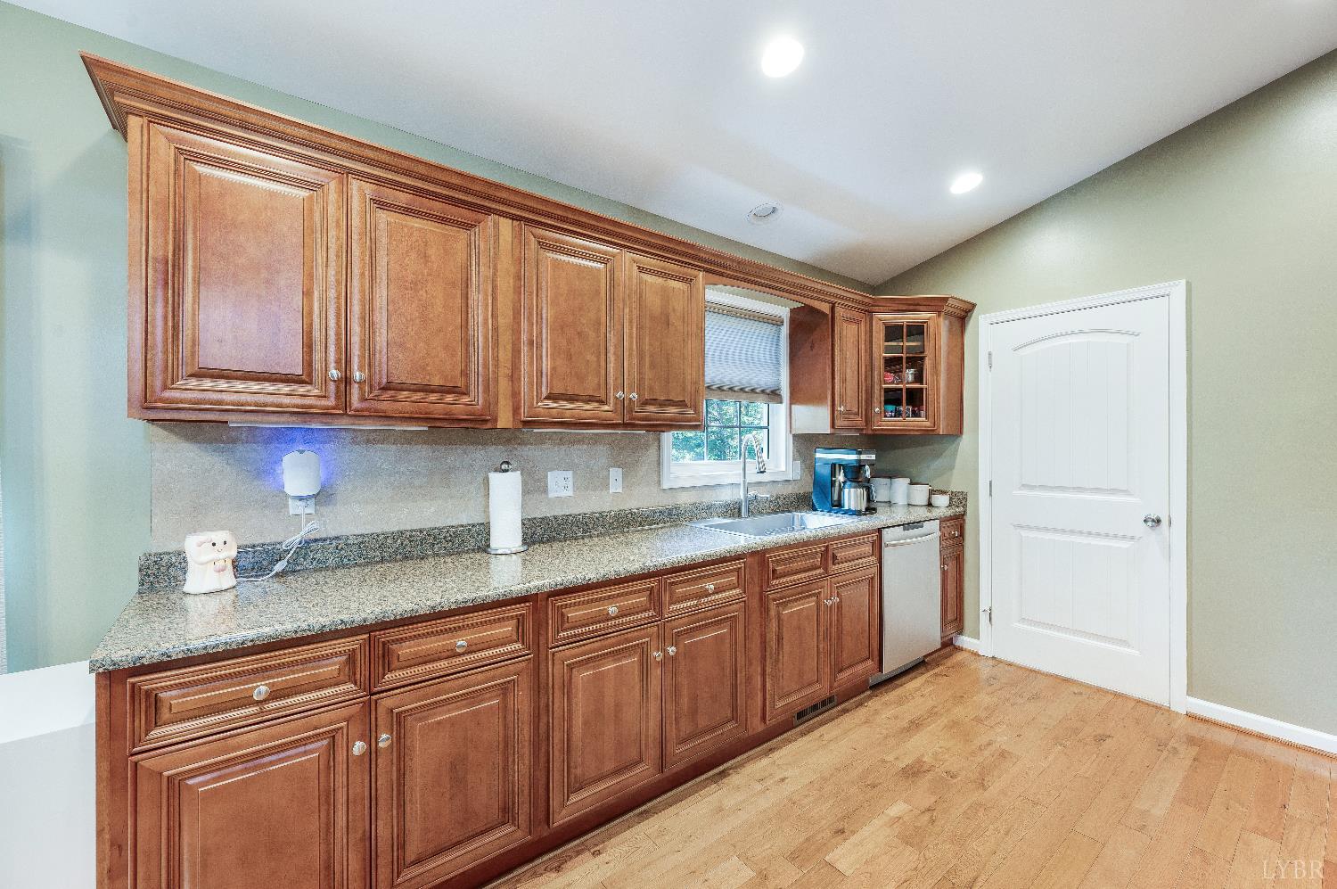 405 Marston Street Spout Spring, VA 24593 - Photo 7 of 58 a kitchen with stainless steel appliances granite countertop a sink and cabinets with wooden floor