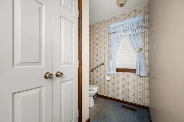a view of a patio with a table and chairs