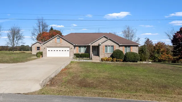 an aerial view of a house with a yard basket ball court