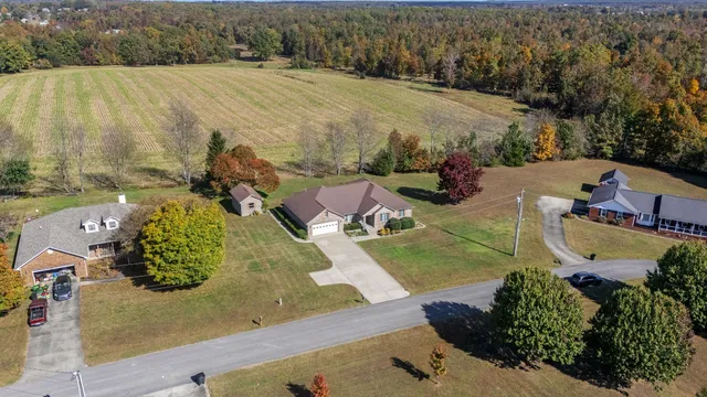 a view of backyard of house and lake
