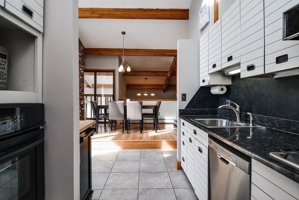 2 Lamplight Circle Natick, MA 01760 - Photo 11 of 23 a kitchen with granite countertop a stove a sink and a cabinets