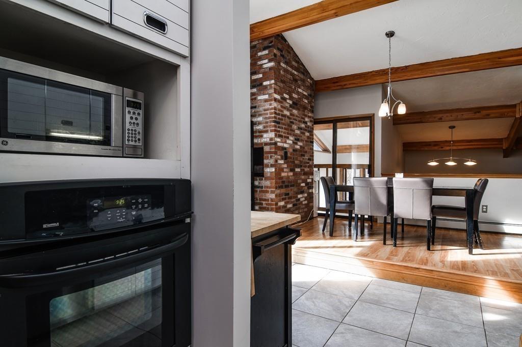 2 Lamplight Circle Natick, MA 01760 - Photo 12 of 23 a dining room with furniture and a fireplace