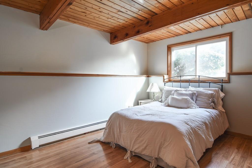2 Lamplight Circle Natick, MA 01760 - Photo 17 of 23 a bed sitting in a bedroom next to a window