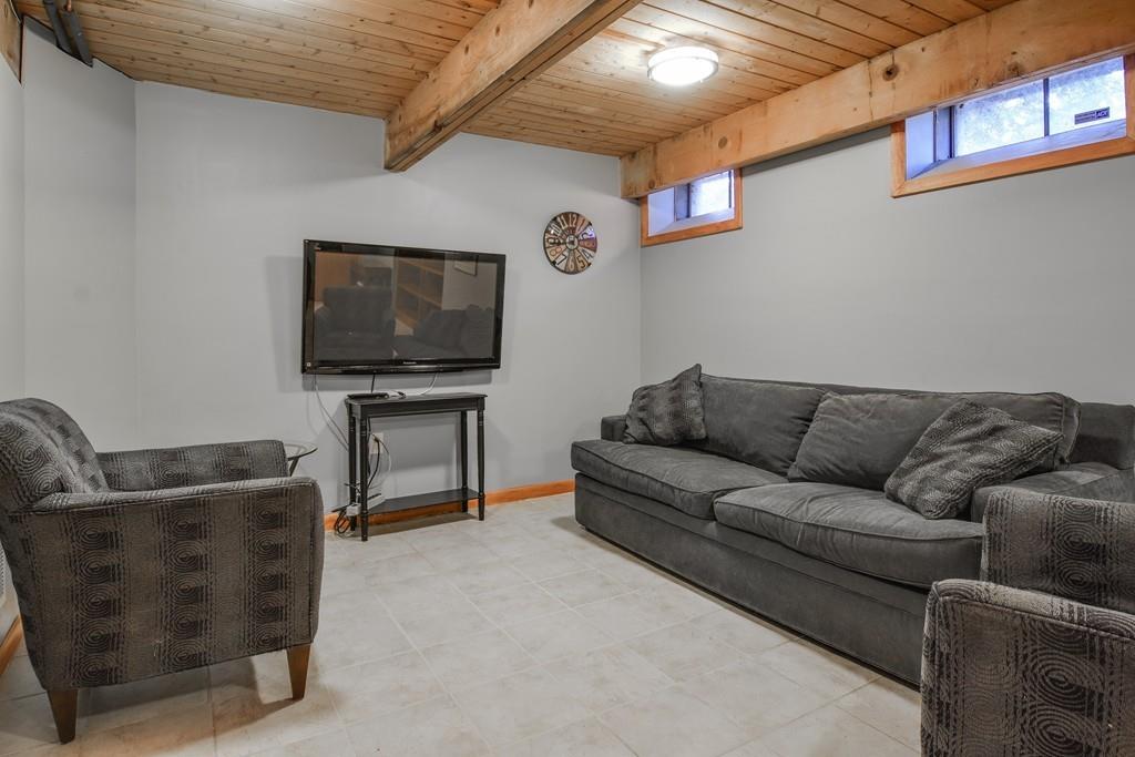 2 Lamplight Circle Natick, MA 01760 - Photo 20 of 23 a living room with furniture and a flat screen tv
