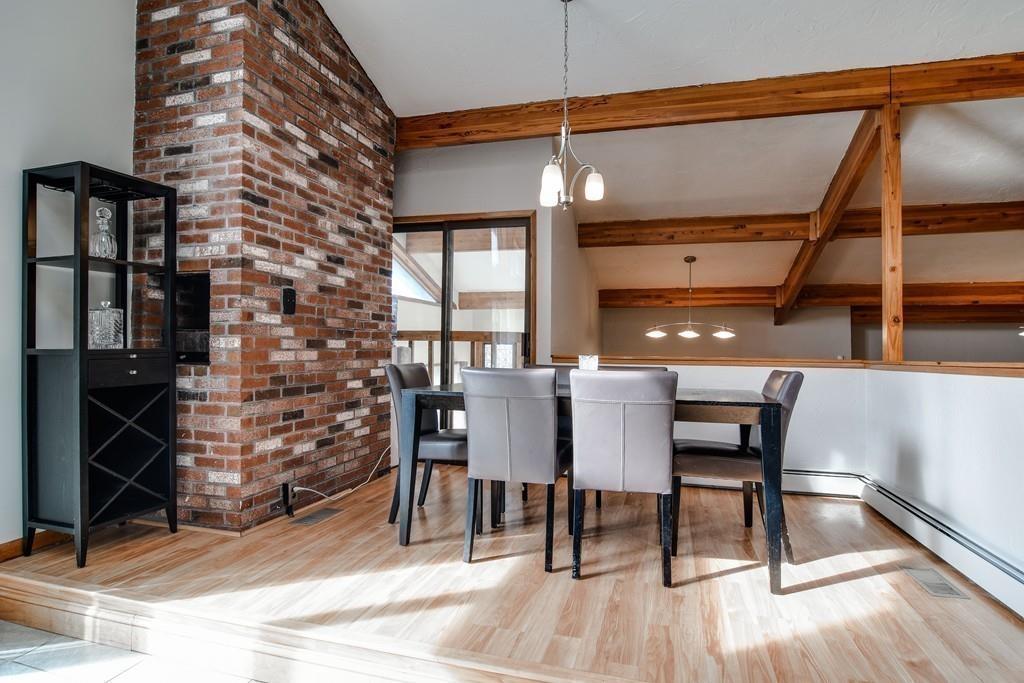 2 Lamplight Circle Natick, MA 01760 - Photo 9 of 23 a dining room with a wooden table and chairs