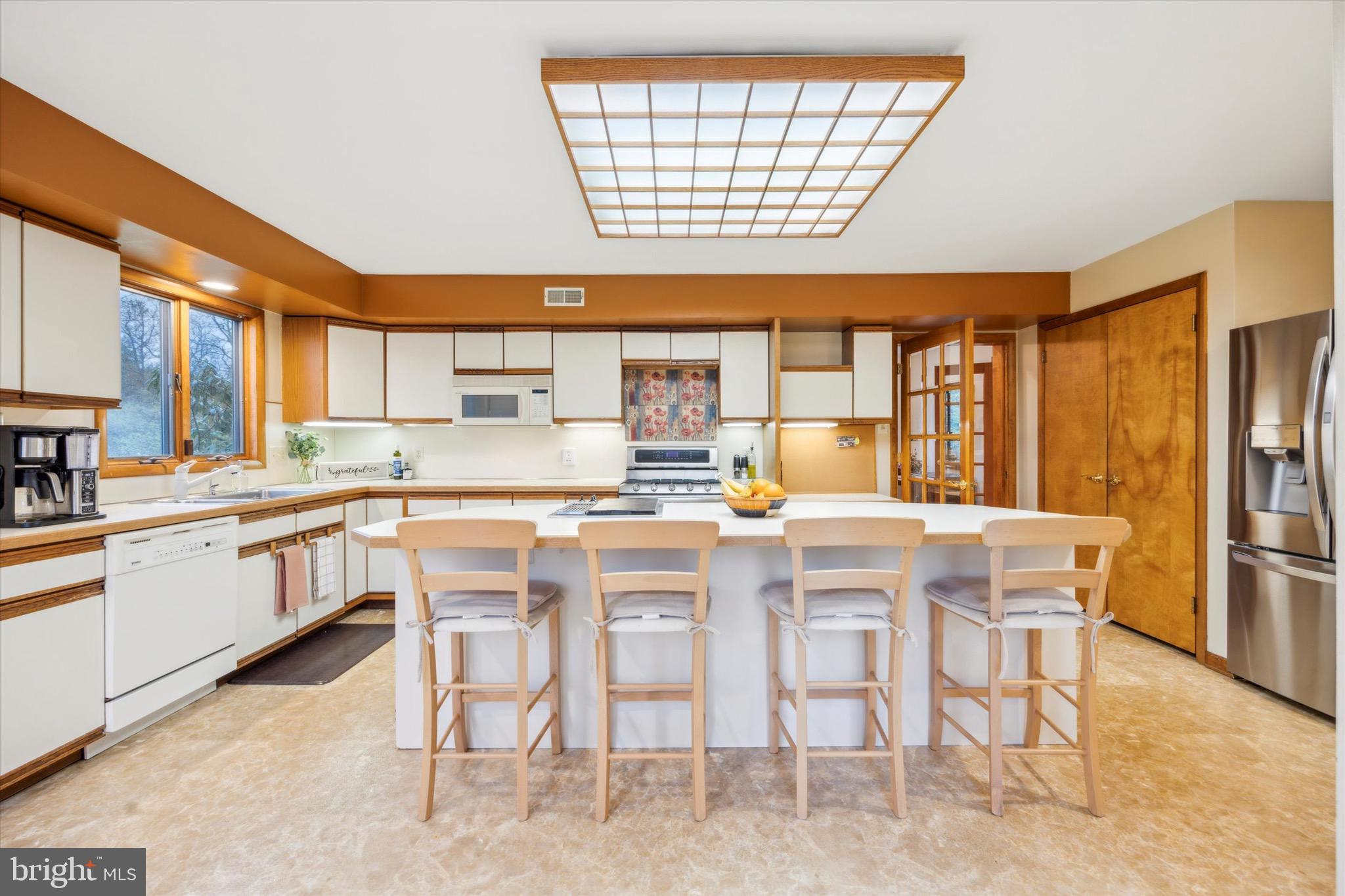 1000 Stonebridge Road Lower Gwynedd, PA 19002 - Photo 28 of 67 a kitchen with a table chairs refrigerator and cabinets