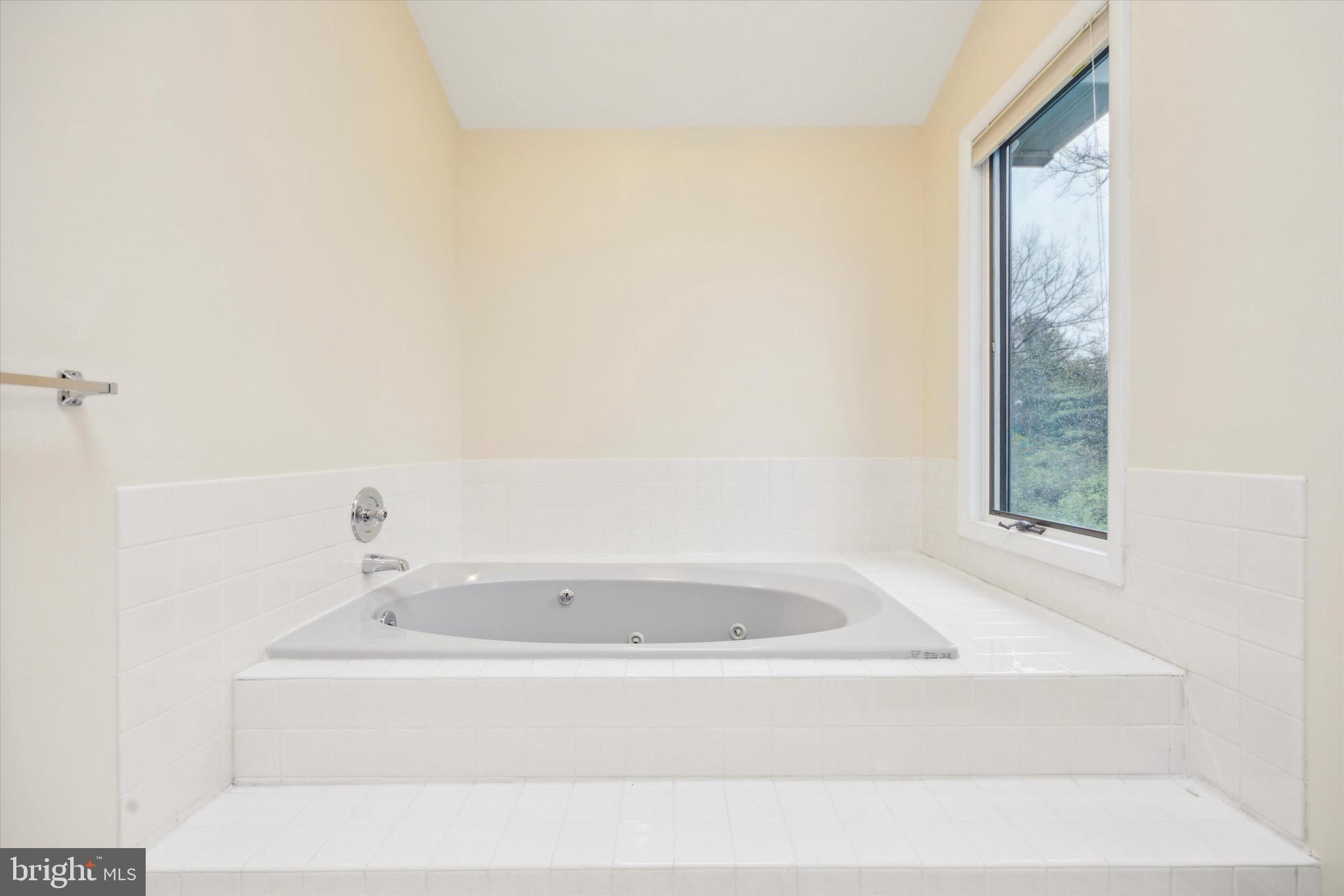 1000 Stonebridge Road Lower Gwynedd, PA 19002 - Photo 41 of 67 a white bath tub sitting in a bathroom next to a window