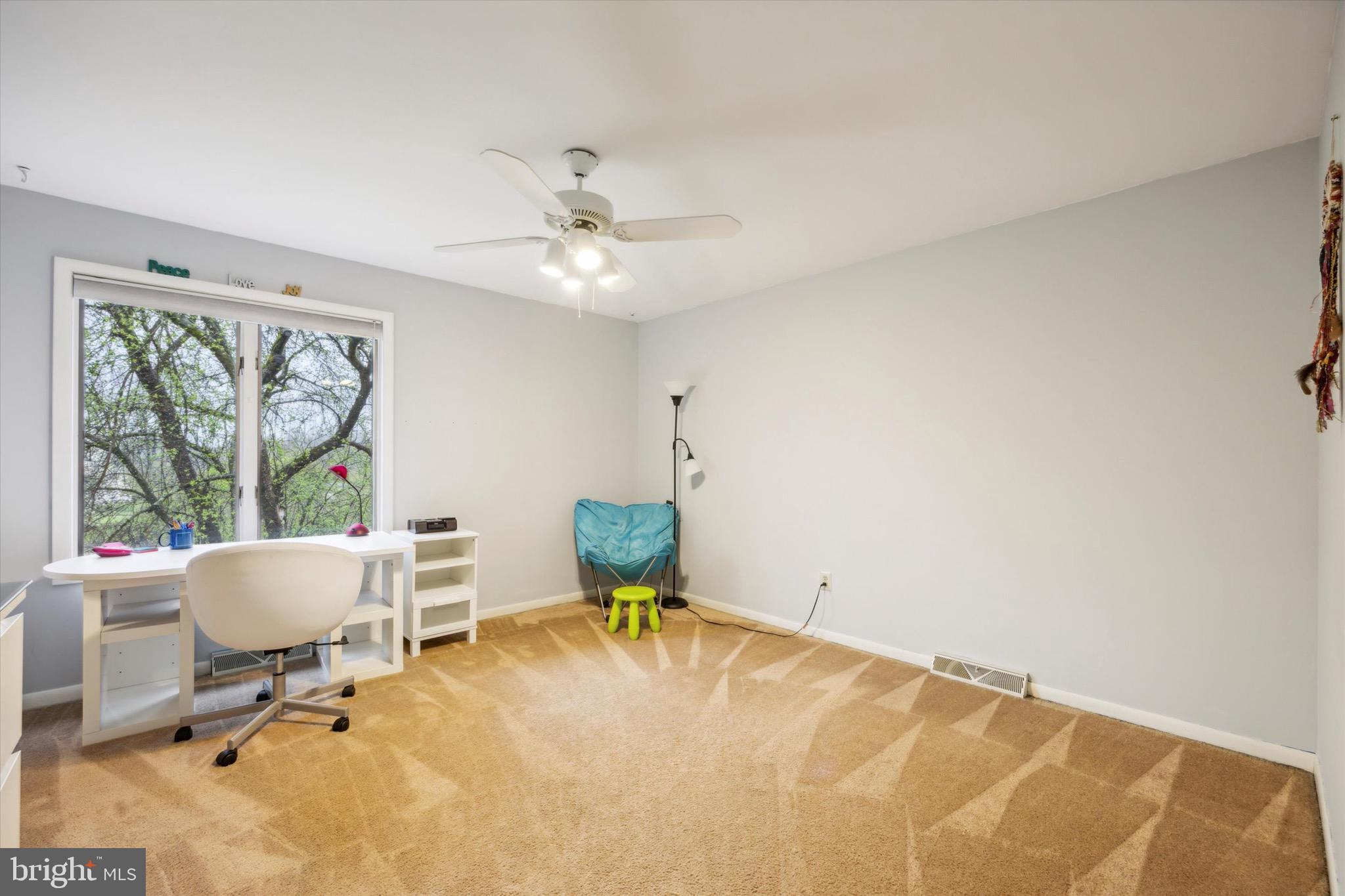 1000 Stonebridge Road Lower Gwynedd, PA 19002 - Photo 46 of 67 a living room with furniture a window and a ceiling fan