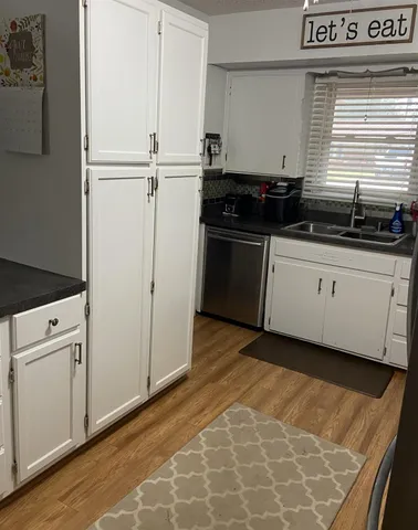 a kitchen with granite countertop cabinets and white appliances