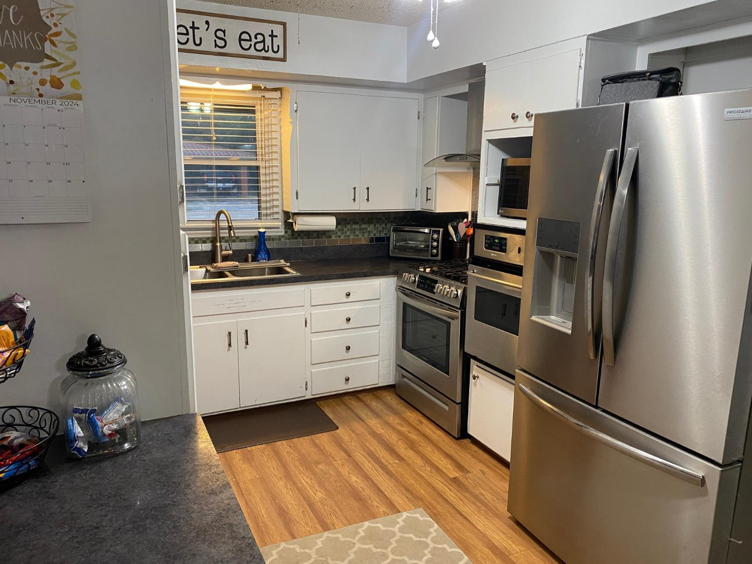 1006 West 11th Street Post, TX 79356 - Photo 14 of 39 a kitchen with stainless steel appliances a refrigerator sink and cabinets