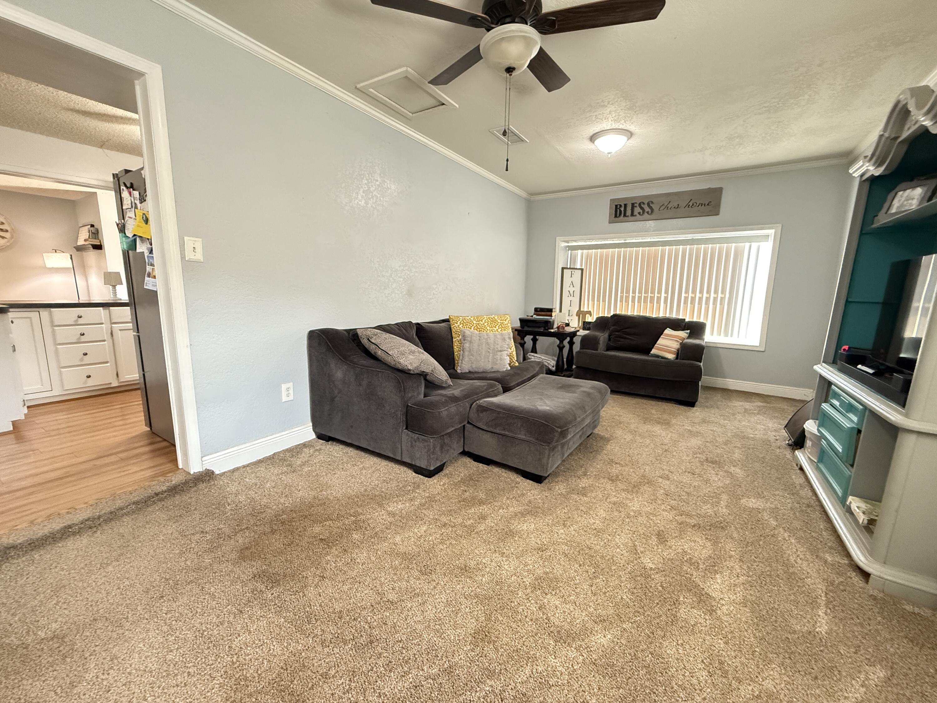 1006 West 11th Street Post, TX 79356 - Photo 15 of 39 a living room with furniture and a flat screen tv