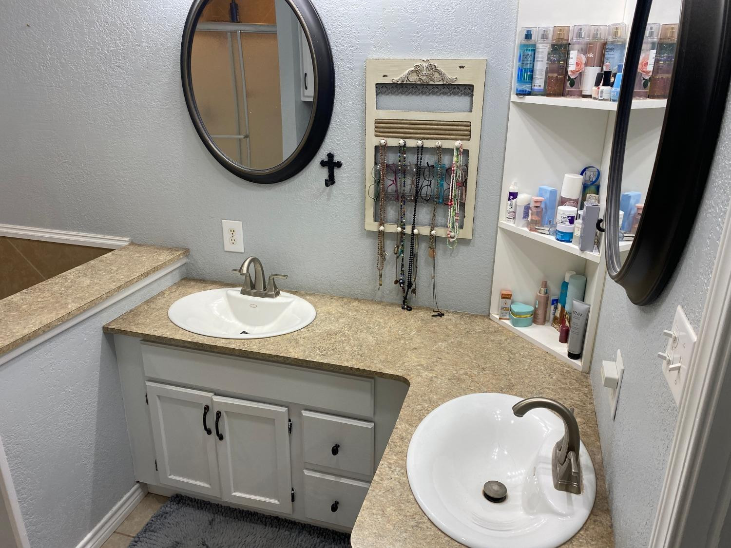 1006 West 11th Street Post, TX 79356 - Photo 25 of 39 a bathroom with a granite countertop sink and a mirror