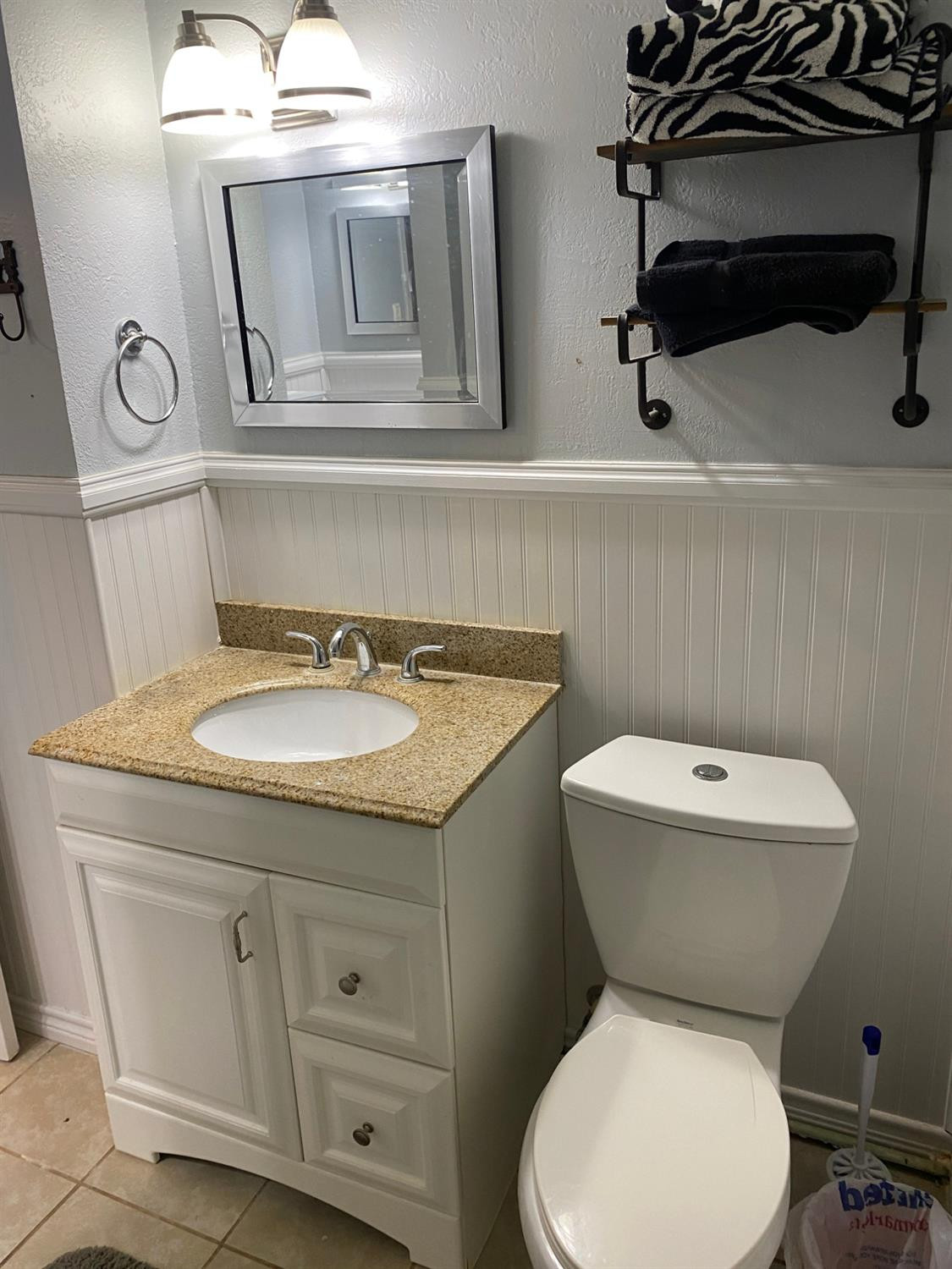 1006 West 11th Street Post, TX 79356 - Photo 29 of 39 a bathroom with a granite countertop toilet sink and mirror