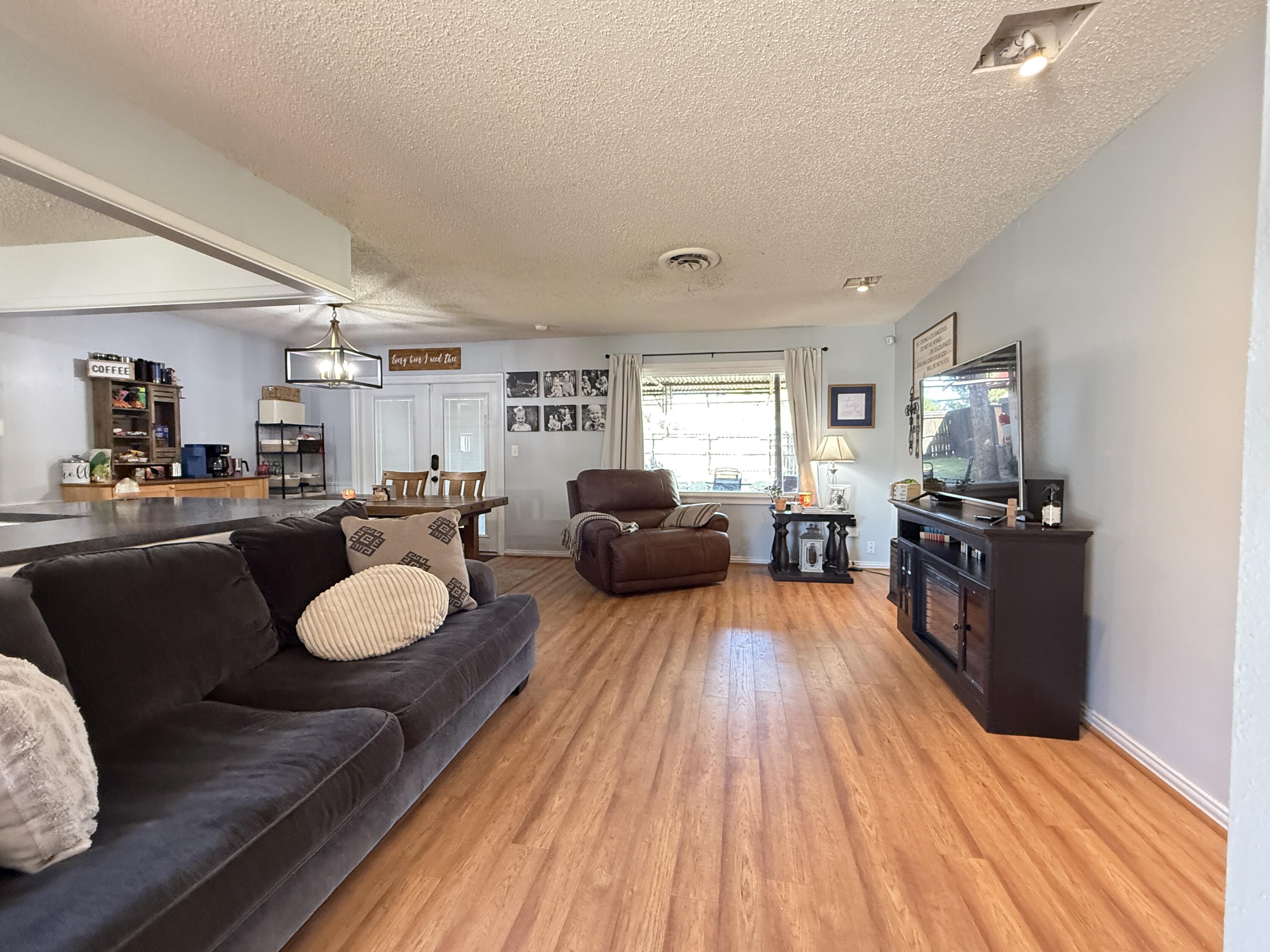 1006 West 11th Street Post, TX 79356 - Photo 4 of 39 a living room with furniture and a wooden floor