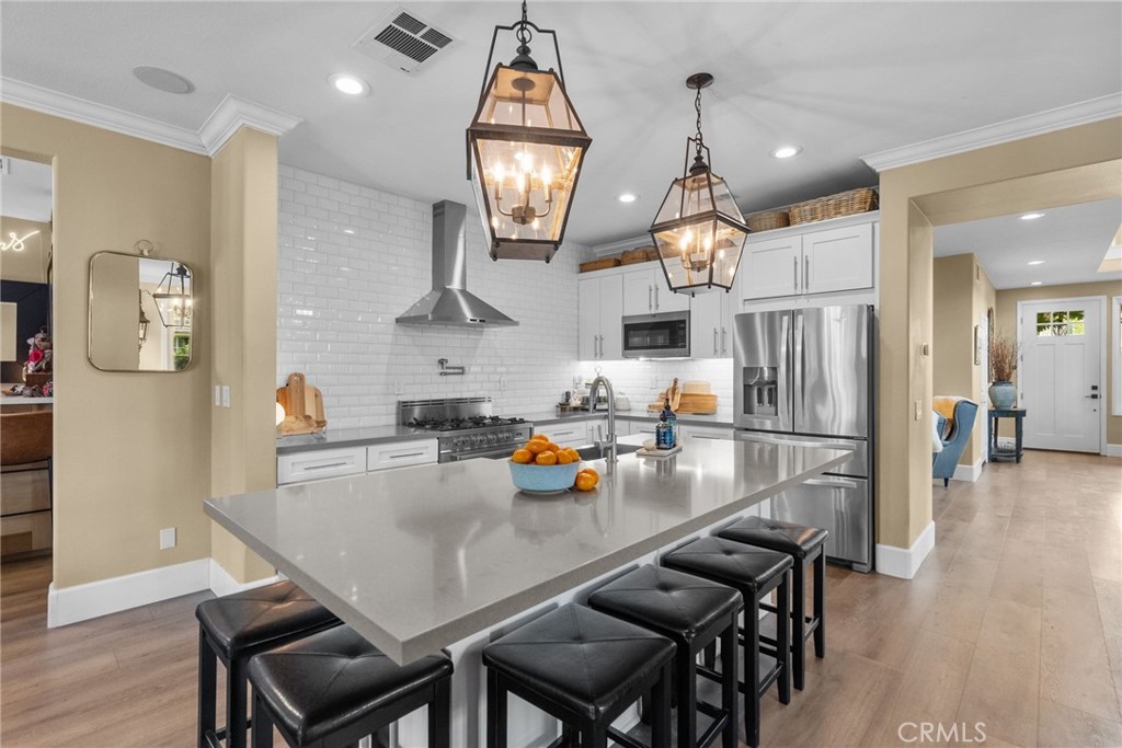 19969 Via Joyce Drive Saugus, CA 91350 - Photo 20 of 66 an open kitchen with a table and chairs