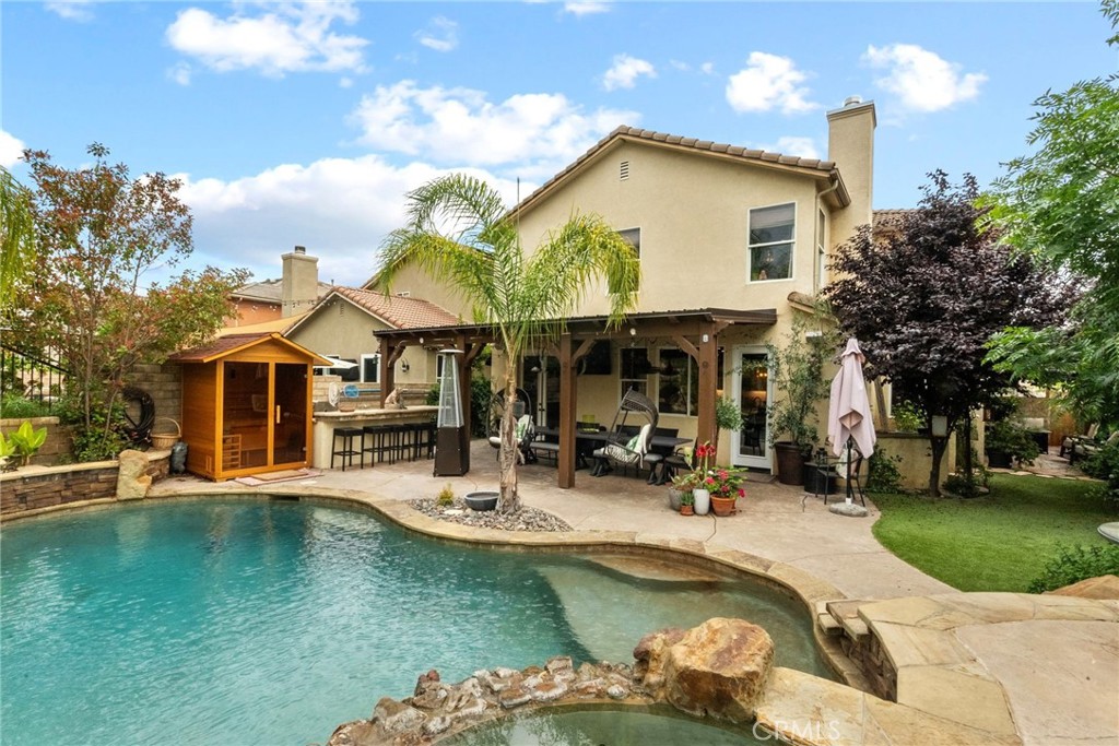 19969 Via Joyce Drive Saugus, CA 91350 - Photo 2 of 66 a view of a patio with a table and chairs under an umbrella