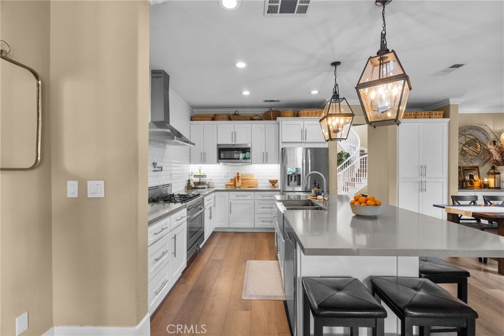 19969 Via Joyce Drive Saugus, CA 91350 - Photo 21 of 66 a kitchen with stainless steel appliances granite countertop a sink refrigerator and cabinets