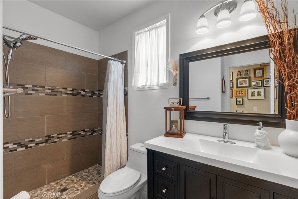 19969 Via Joyce Drive Saugus, CA 91350 - Photo 28 of 66 a bathroom with a double vanity sink toilet mirror and windows