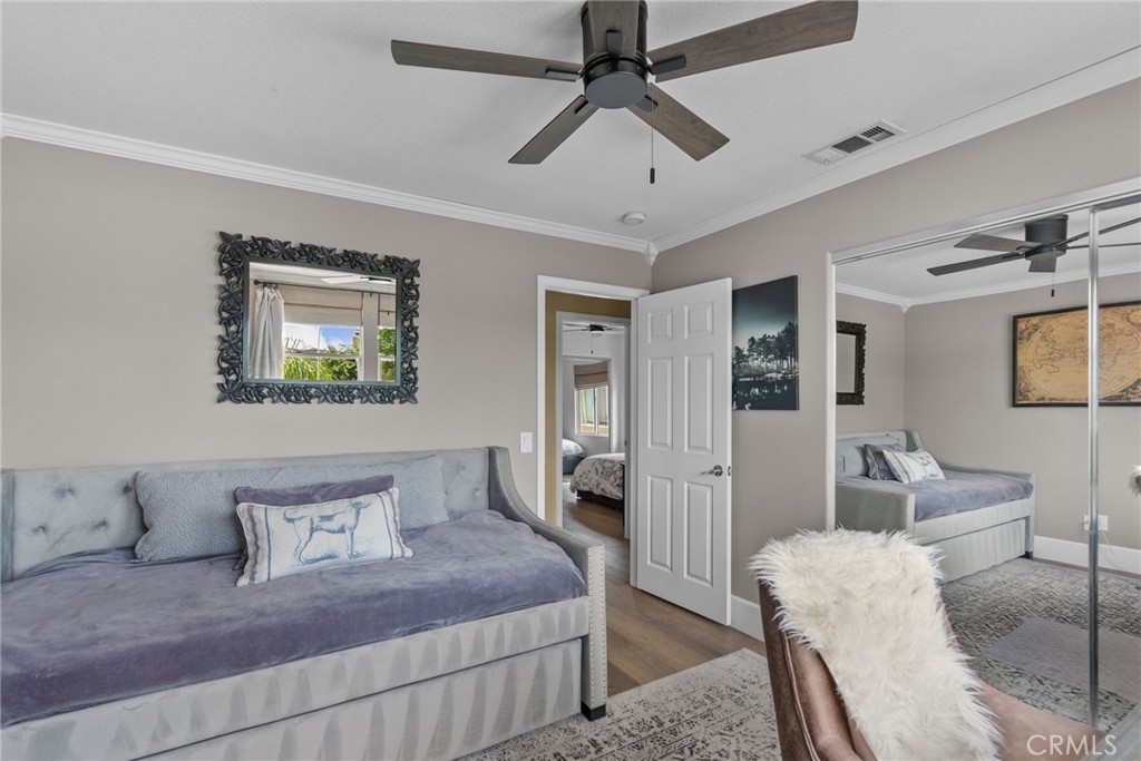 19969 Via Joyce Drive Saugus, CA 91350 - Photo 49 of 66 a bedroom with a bed and a chandelier