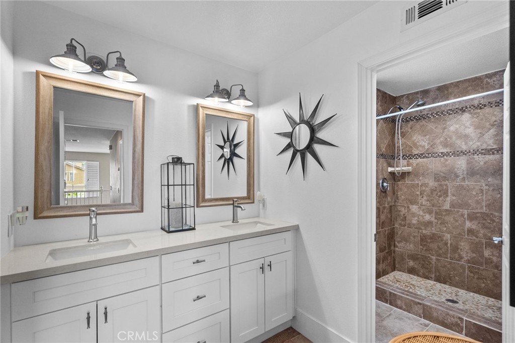 19969 Via Joyce Drive Saugus, CA 91350 - Photo 51 of 66 a bathroom with a double vanity sink mirror and shower