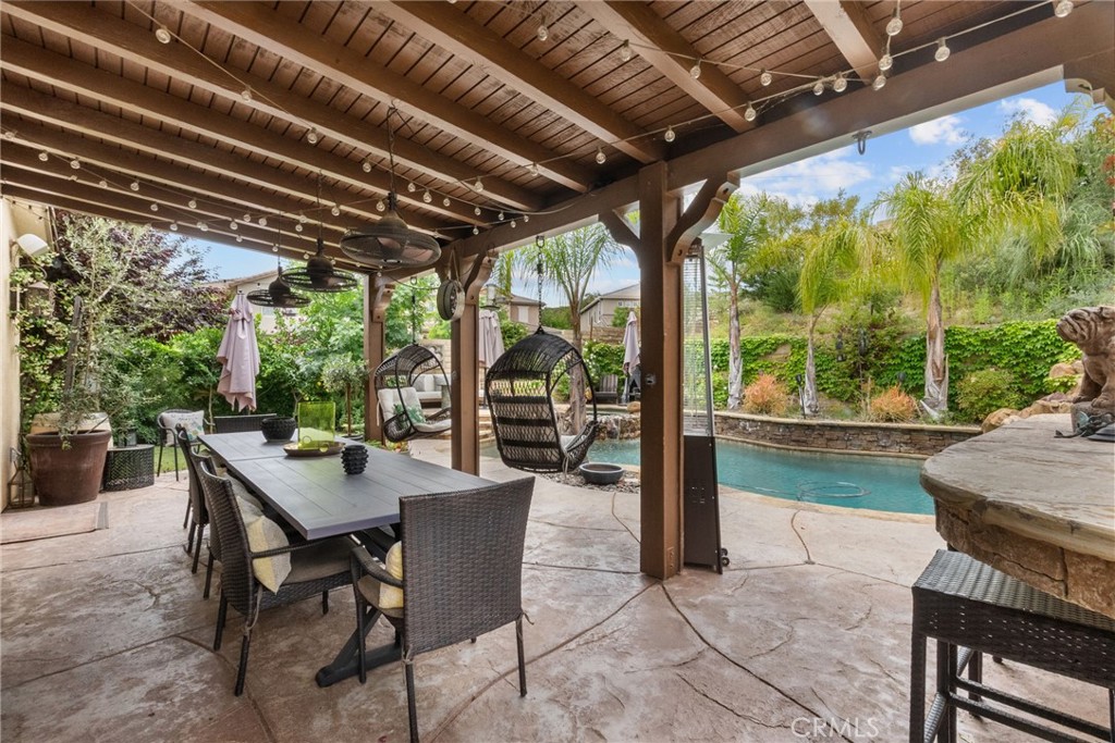 19969 Via Joyce Drive Saugus, CA 91350 - Photo 60 of 66 a view of a patio with table and chairs and potted plants