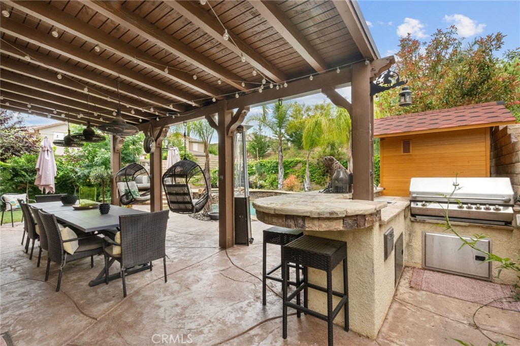 19969 Via Joyce Drive Saugus, CA 91350 - Photo 61 of 66 a view of a patio with table and chairs and potted plants