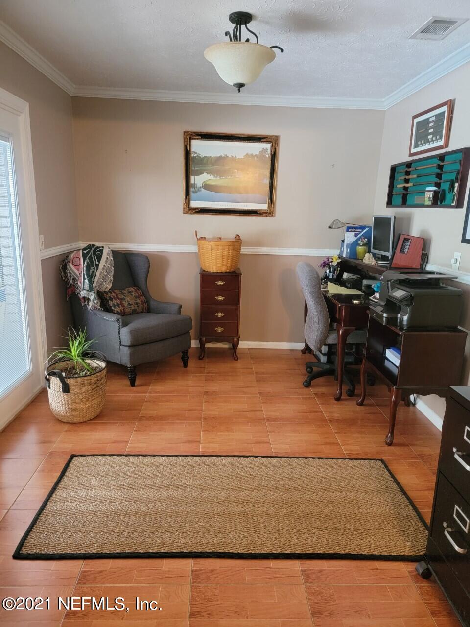 13033 Mandarin Road Jacksonville, FL 32223 - Photo 9 of 11 a living room with furniture rug and window