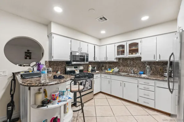 a kitchen with sink cabinets and window