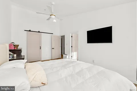 a bathroom with a granite countertop sink a toilet and shower
