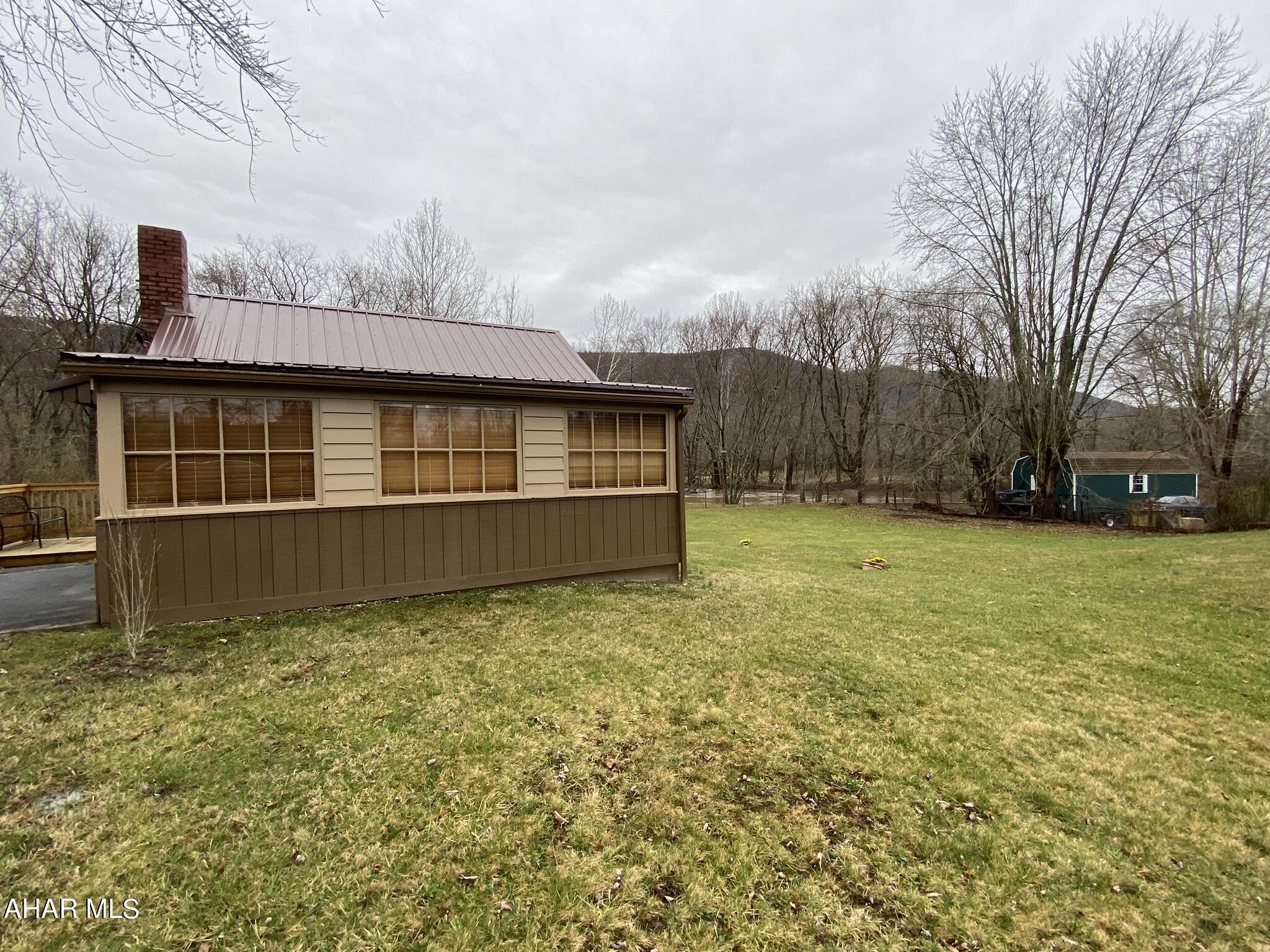 157 Stuckeysville Road Manns Choice, PA 15550 - Photo 19 of 28 a backyard of a house with large trees