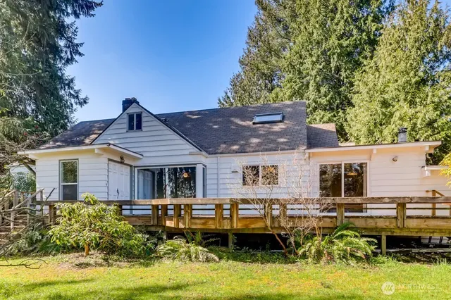 a backyard of a house with yard table and chairs