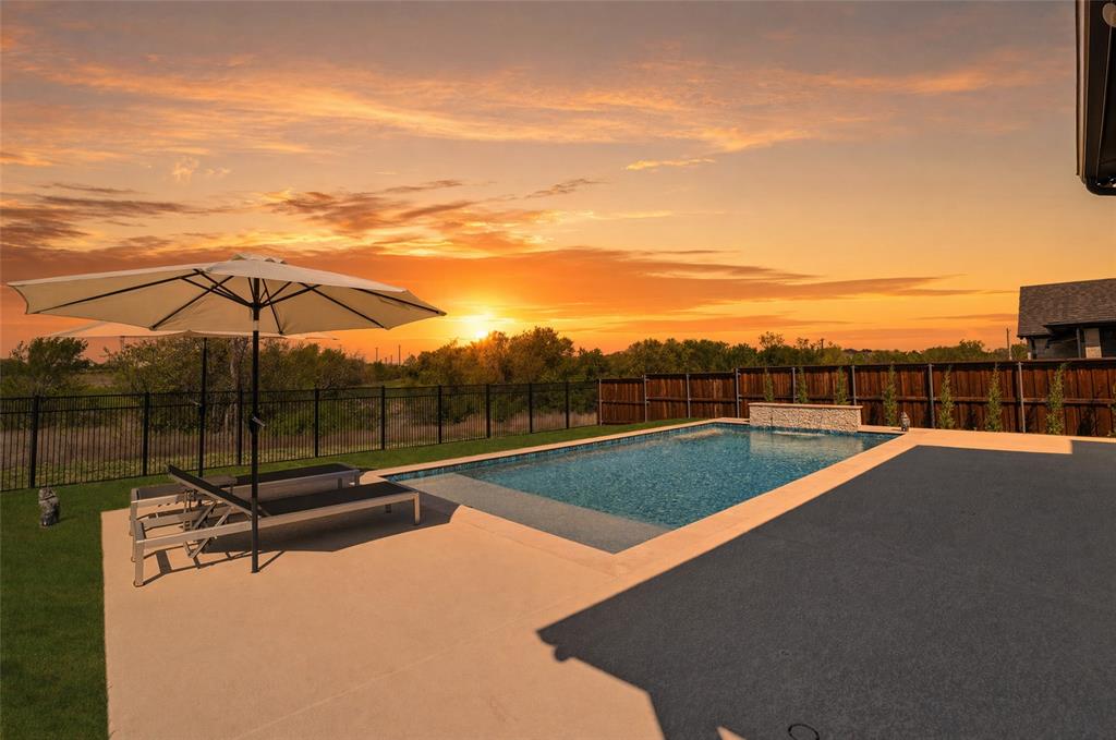 2721 Rotherham Street Prosper, TX 75078 - Photo 2 of 37 a view of a tennis court with a large tree in the background