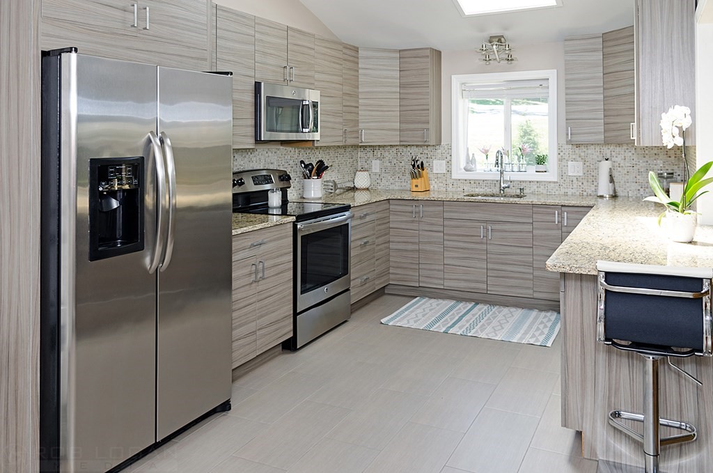 25 Cherry Road Framingham, MA 01701 - Photo 3 of 14 a kitchen with stainless steel appliances granite countertop a sink stove and refrigerator