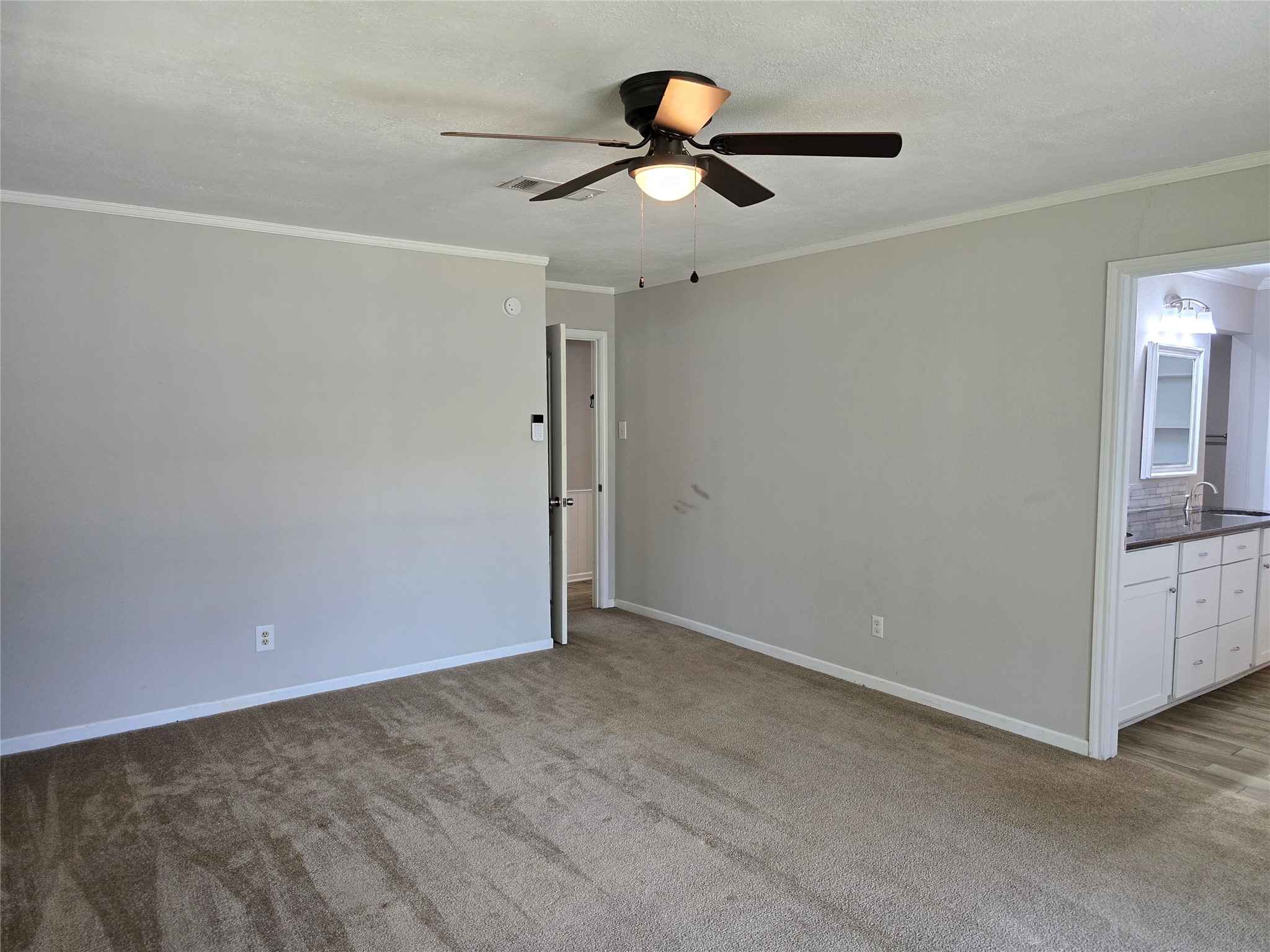 205 East Cherokee Drive Harker Heights, TX 76548 - Photo 14 of 23 A versatile living space with plush carpeting, leading into a well-appointed kitchen.