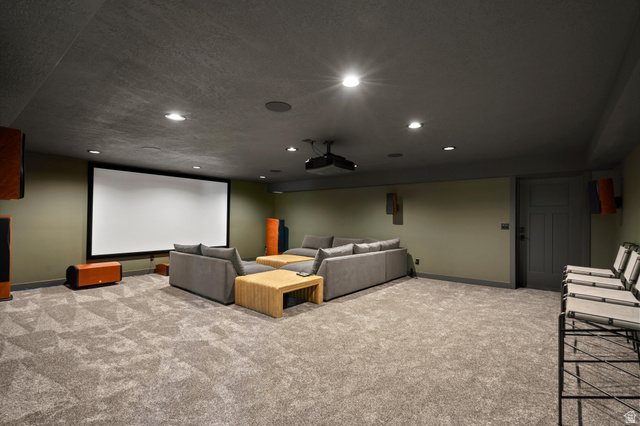 4499 North Seven Bridges Road, Unit 9 Eden, UT 84310 - Photo 45 of 65 Expansive carpeted room featuring a large projection screen, recessed lighting, and a paneled interior door