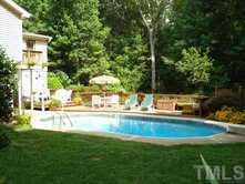 11204 Coachmans Way Raleigh, NC 27614 - Photo 9 of 10 a view of swimming pool with lawn chairs and plants
