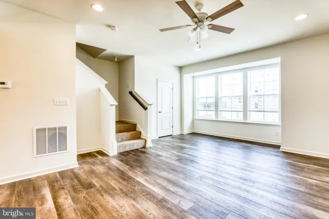 a view of an empty room and wooden floor