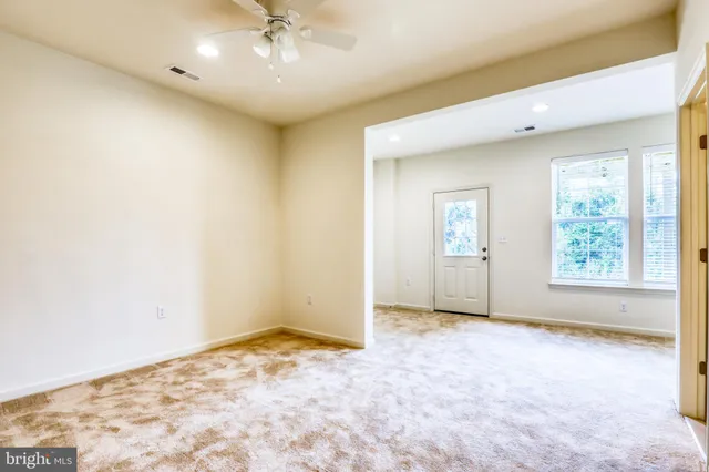 an empty room with windows and closet