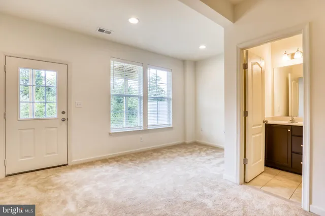 a bathroom with a double vanity sink toilet and a mirror