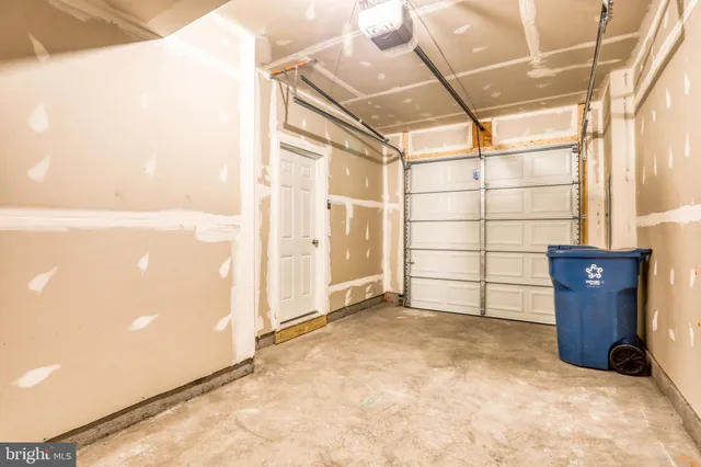 a front view of a house with a garage and balcony