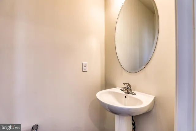 a kitchen with stainless steel appliances kitchen island granite countertop a stove a sink and a refrigerator with wooden floors