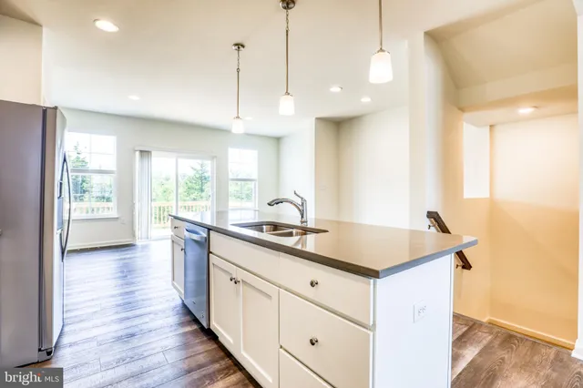 a kitchen with stainless steel appliances granite countertop a stove a microwave and a refrigerator