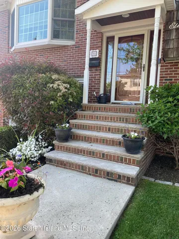 a view of a chair and table in backyard of the house