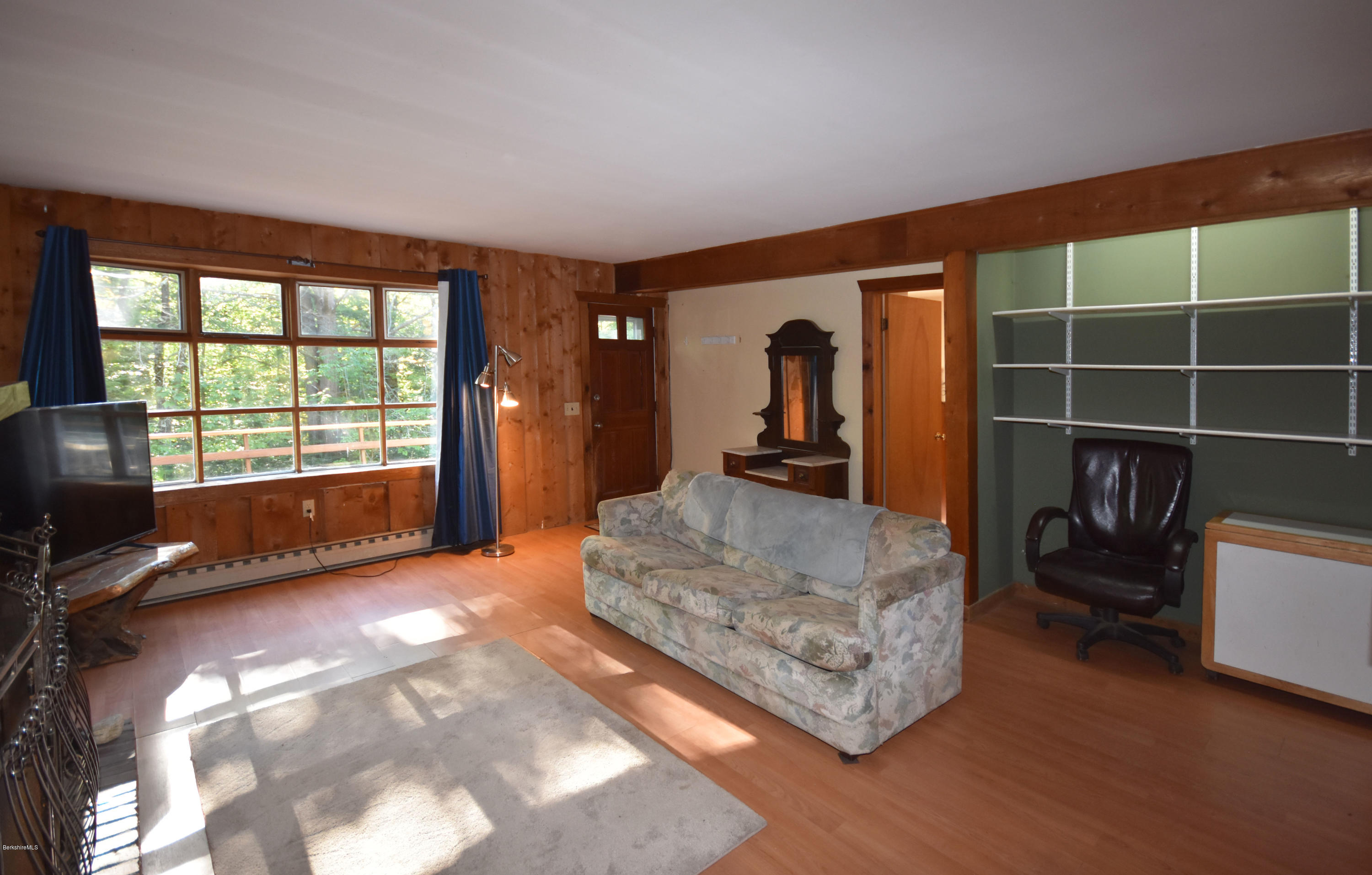 211 Woodmere Road Becket, MA 01223 - Photo 8 of 56 a view of an empty room with furniture and a window