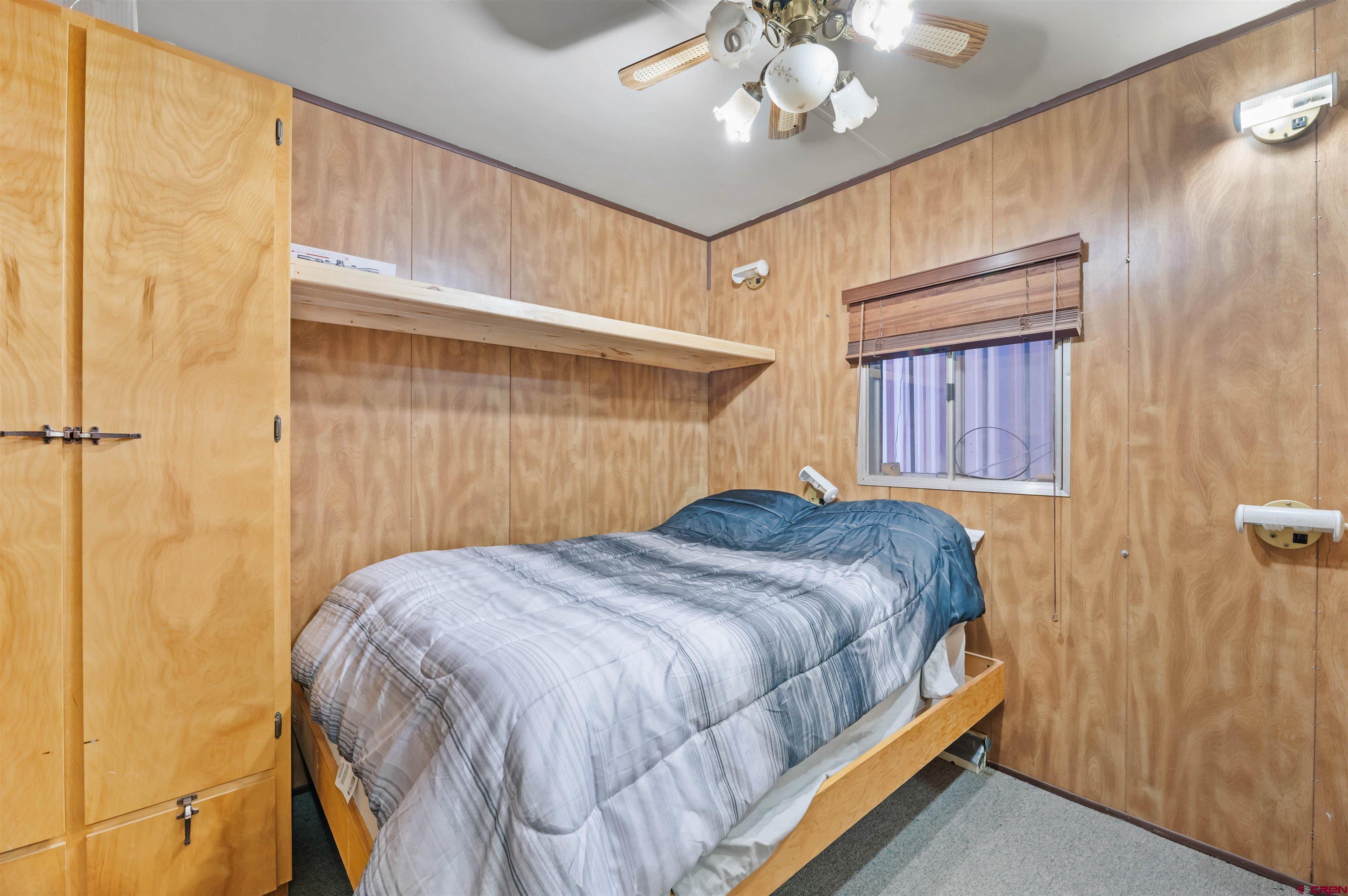 106 County Road 106 Hesperus, CO 81326 - Photo 37 of 44 a bedroom with a bed and a chandelier